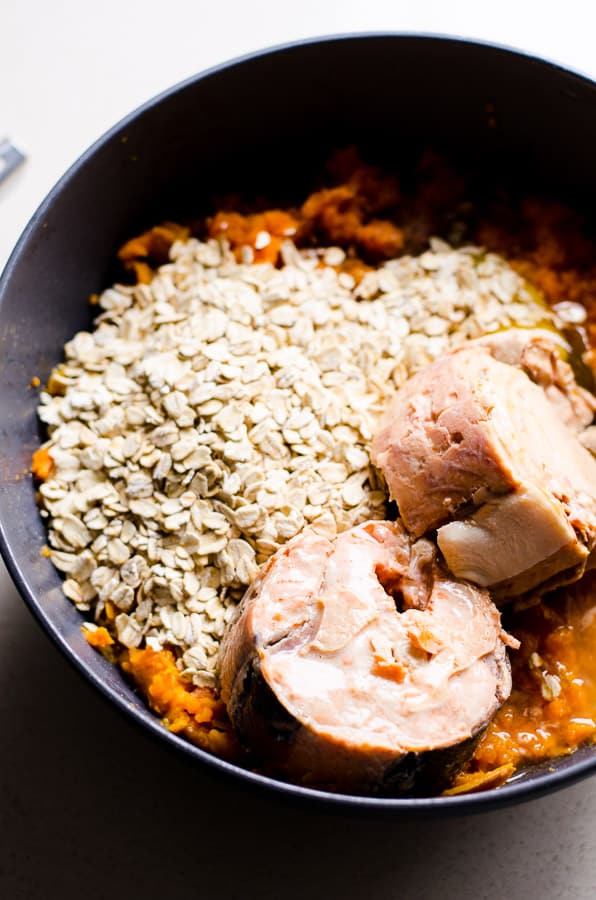  canned salmon, oatmeal and cooked sweet potatoes in a bowl; unmixed. 