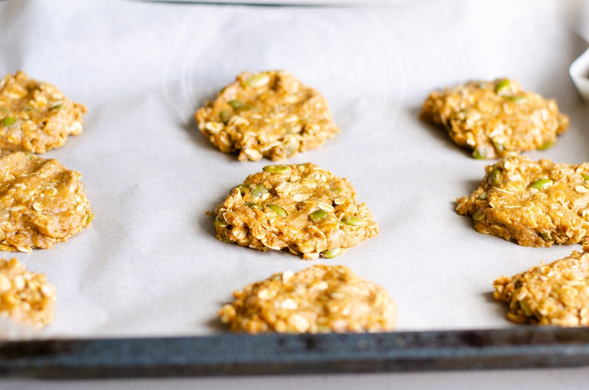 Unbaked cookies on parchment lined baking pan.