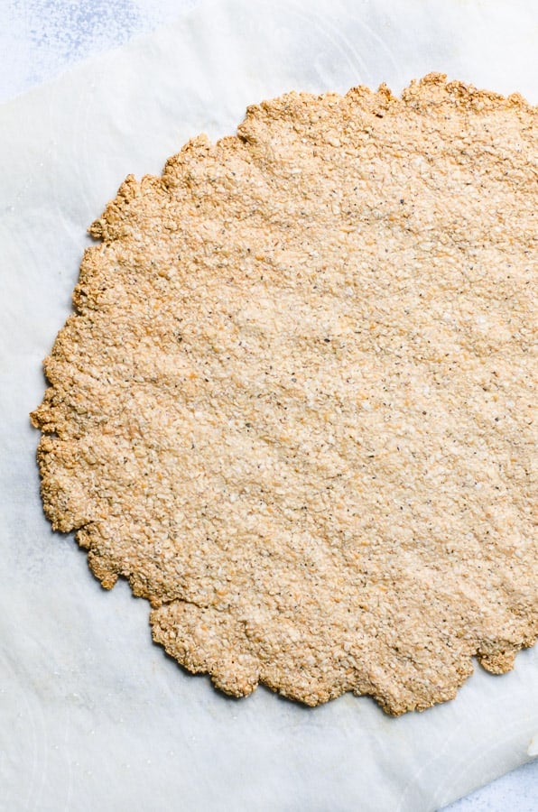Baked Oatmeal Pizza Crust on parchment paper.