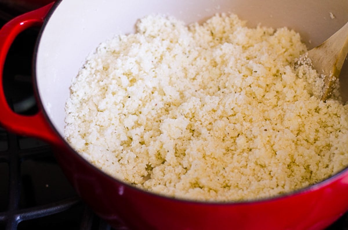 Cauliflower rice in red dutch oven.