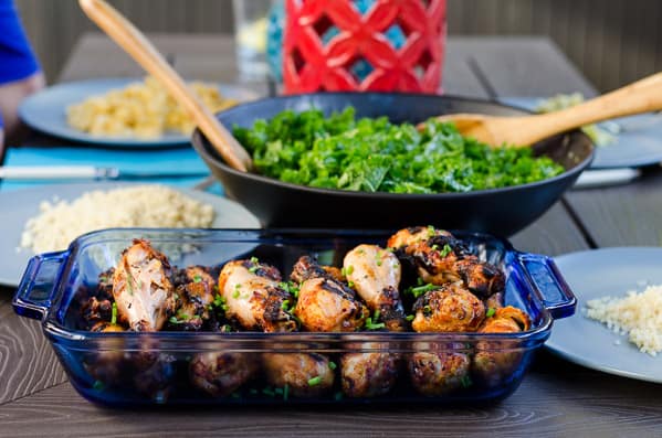 miso marinated chicken, kale salad and rice on blue plates on table