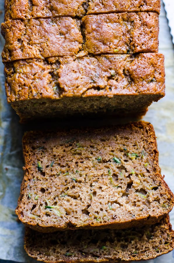 Sliced healthy zucchini bread on parchment paper.