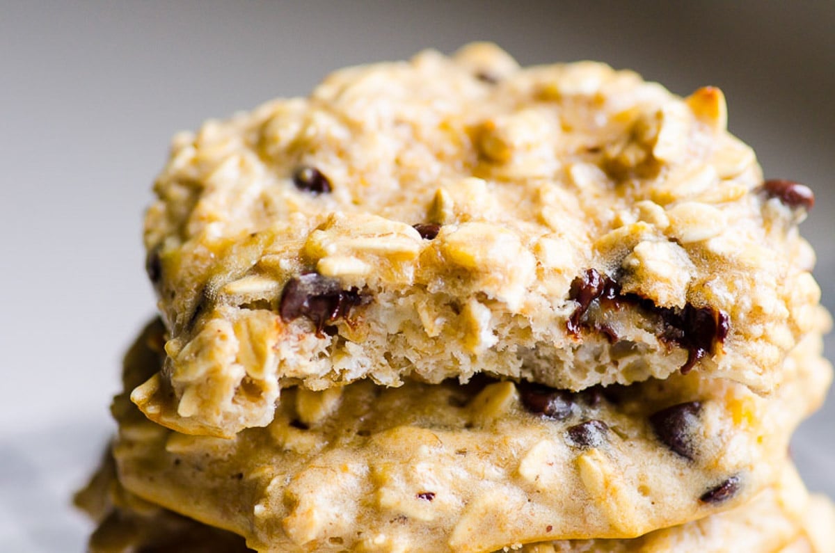 A stack of protein cookies with the top one missing a bite.