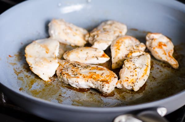 searing chicken breasts in a skillet