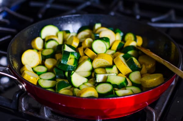 Chopped zucchini in a skillet.