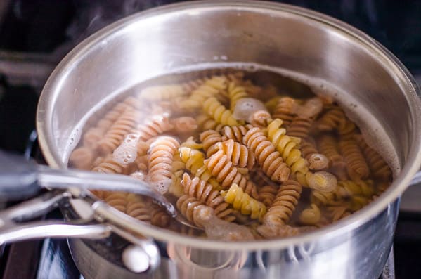 Pasta cooking in a pot with water.