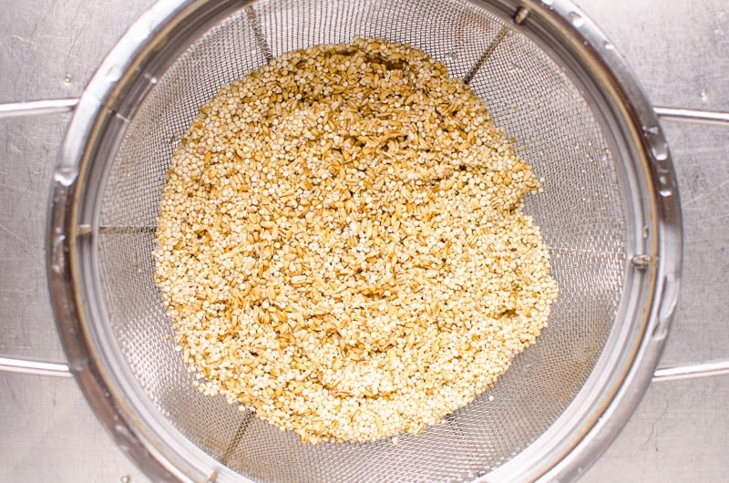 quinoa and oats rinsed in a colander
