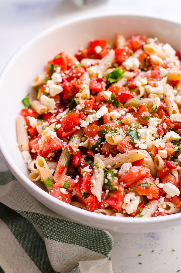Tomato Pasta Salad in a bowl garnished with parsley