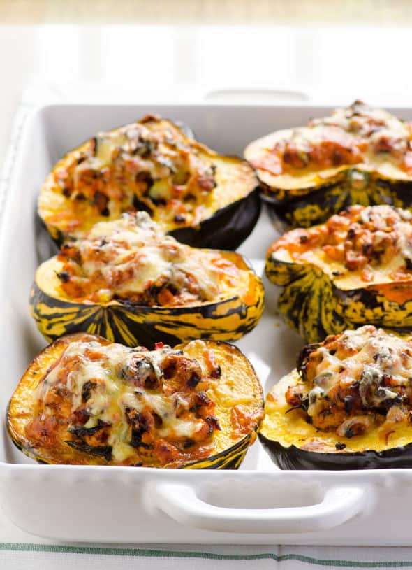 Ground turkey stuffed acorn squash in baking dish.