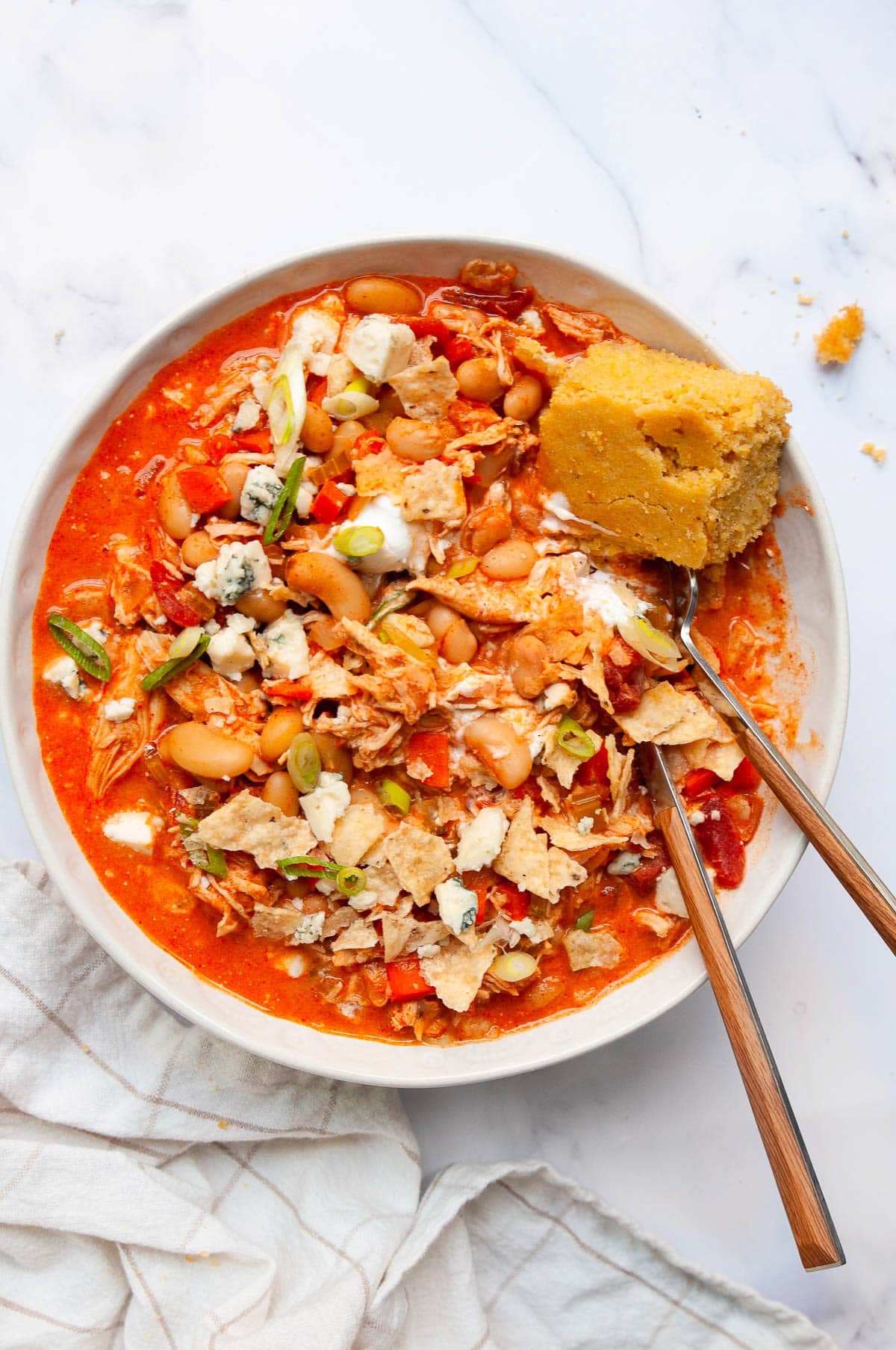 buffalo chicken wing chili in a bowl with garnish