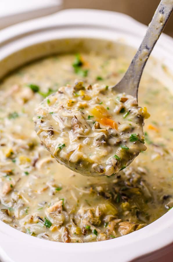chicken and wild rice soup crock pot on a ladle for serving