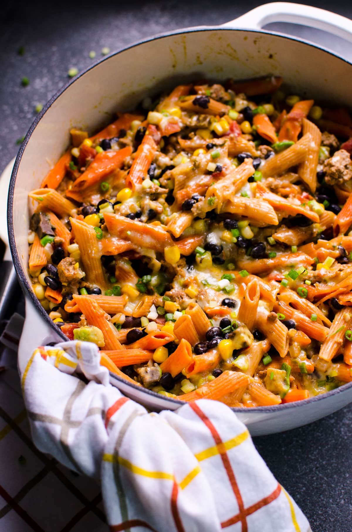 Healthy taco pasta in large pot with a towel wrapped around handle.