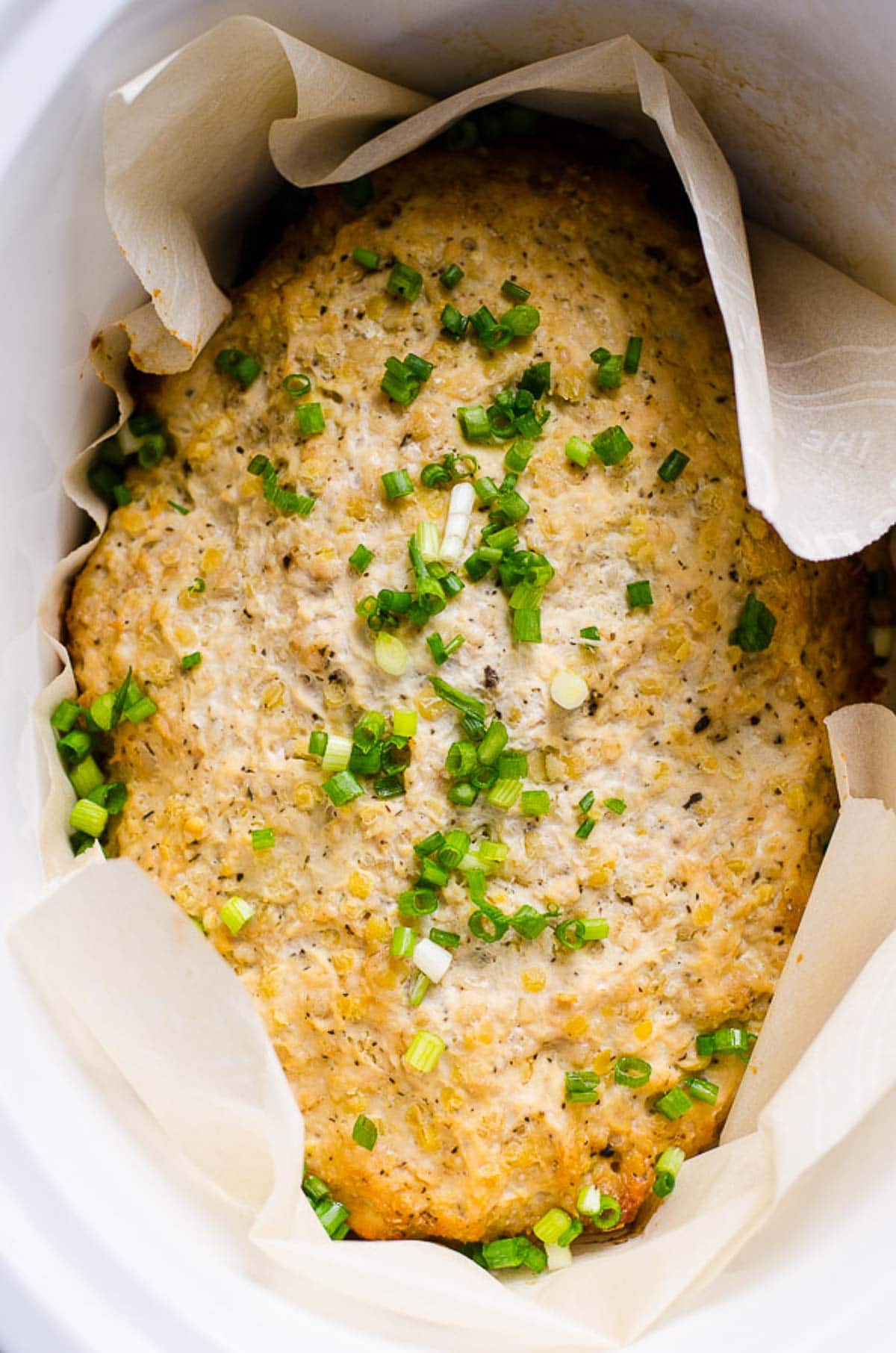 Slow cooker turkey meatloaf in parchment paper lined crockpot.