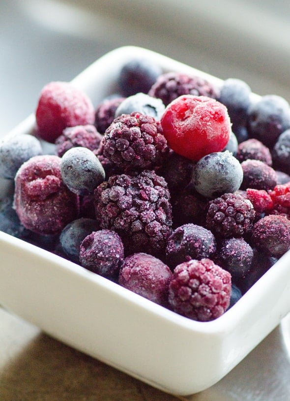 frozen berries in white bowl