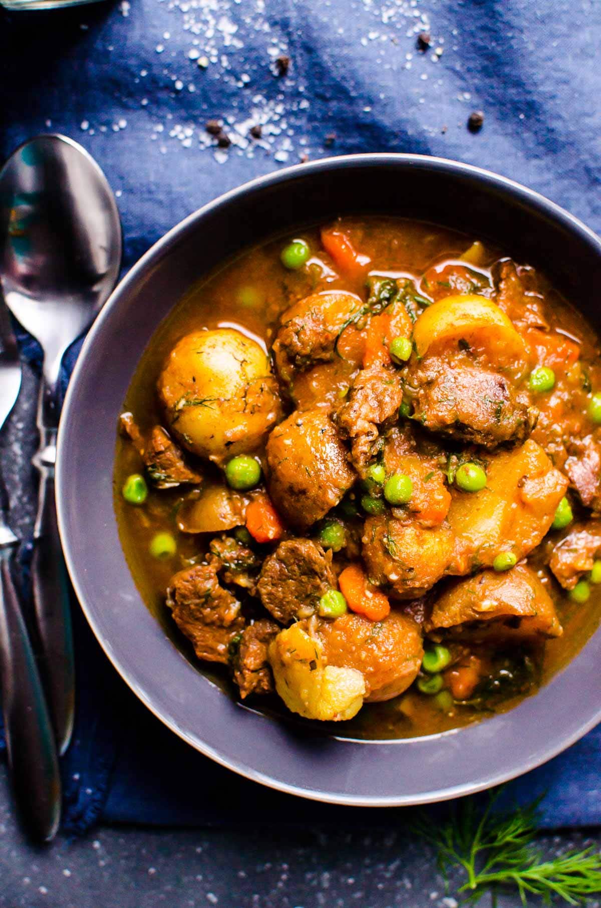 Instant Pot Beef Stew in a bowl with spoon and fork