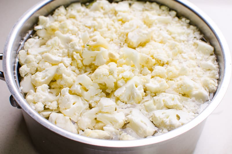 Raw cauliflower with water in a pot.