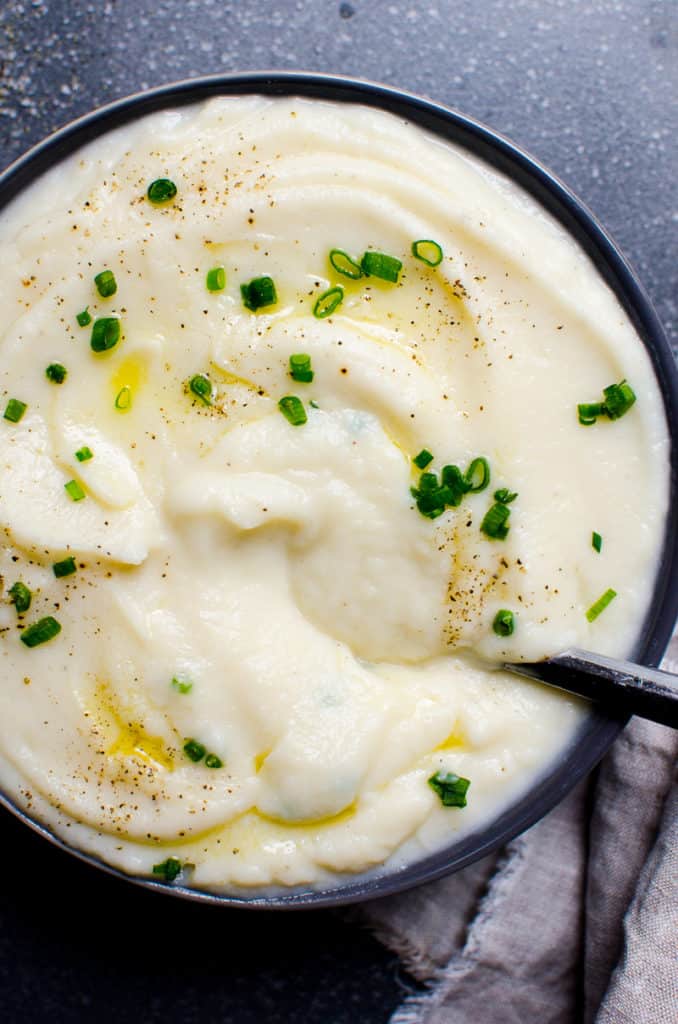 cauliflower mashed potatoes with butter chives and in a bowl