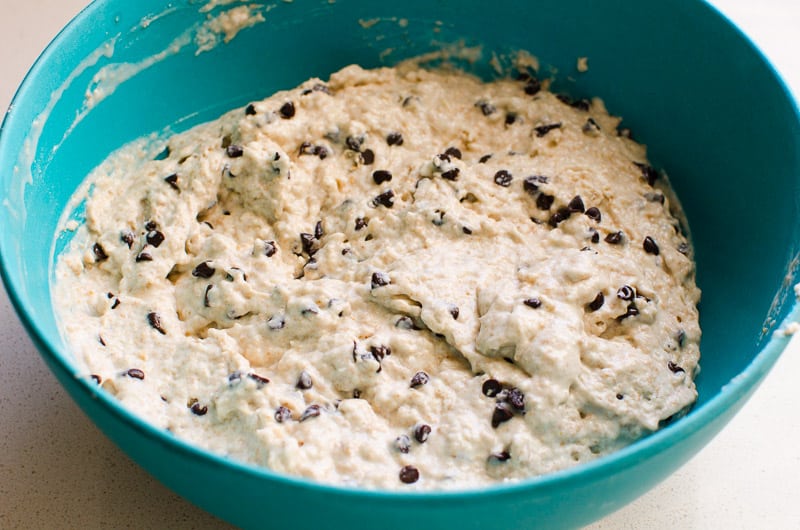 Healthy chocolate chip muffins batter in blue bowl.