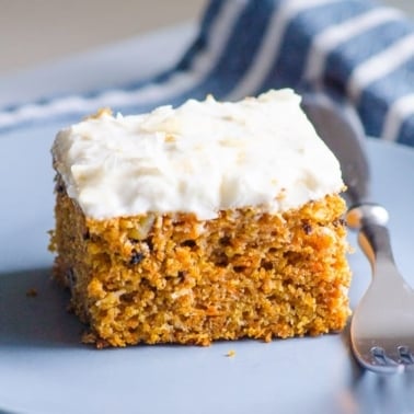 Healthy carrot cake on blue plate with a fork.