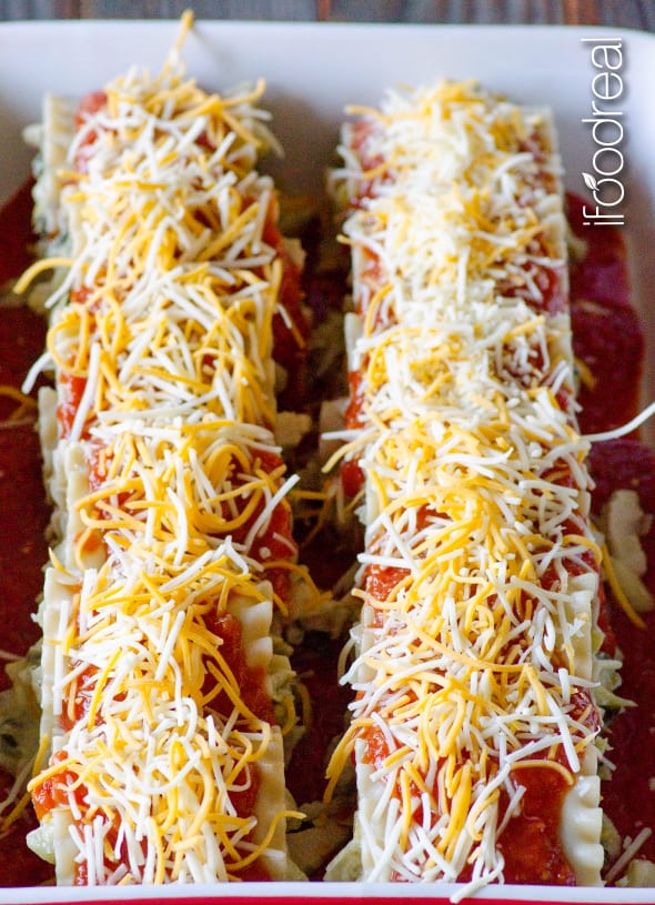 Chicken Lasagna Roll Ups with shredded cheese on top