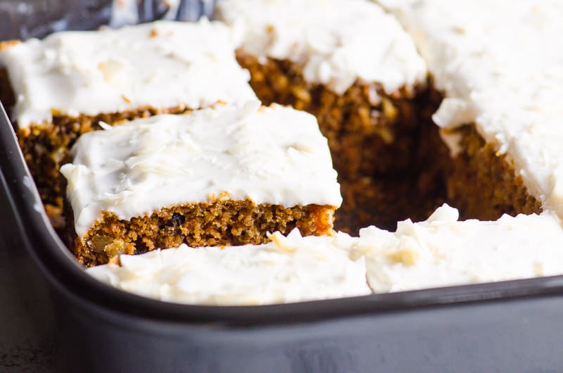 Healthy carrot cake slices in baking pan.