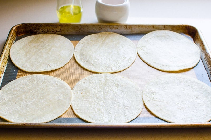 corn tortillas on baking sheet