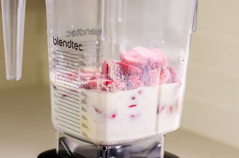 almond milk, strawberries, banana and flaxseed in a blender jug