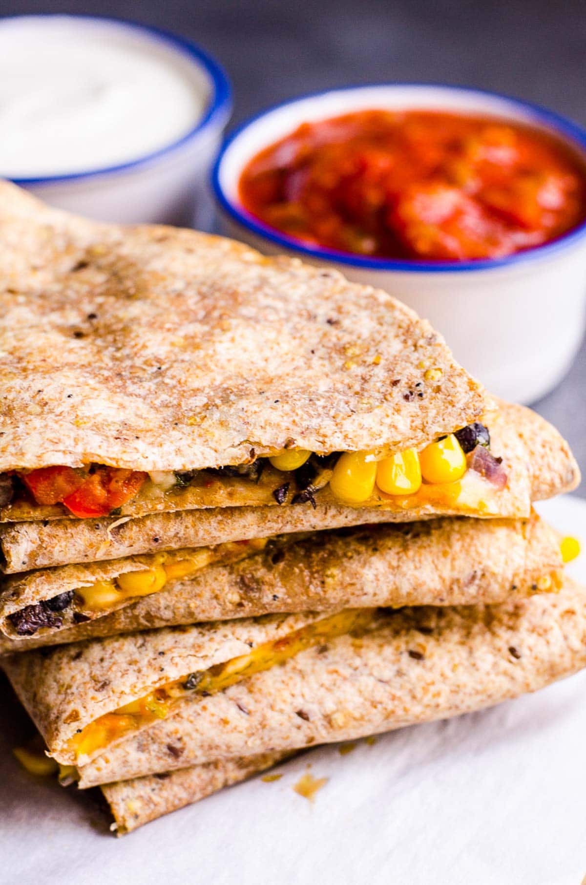 Folded veggie quesadillas stacked on top of each other.