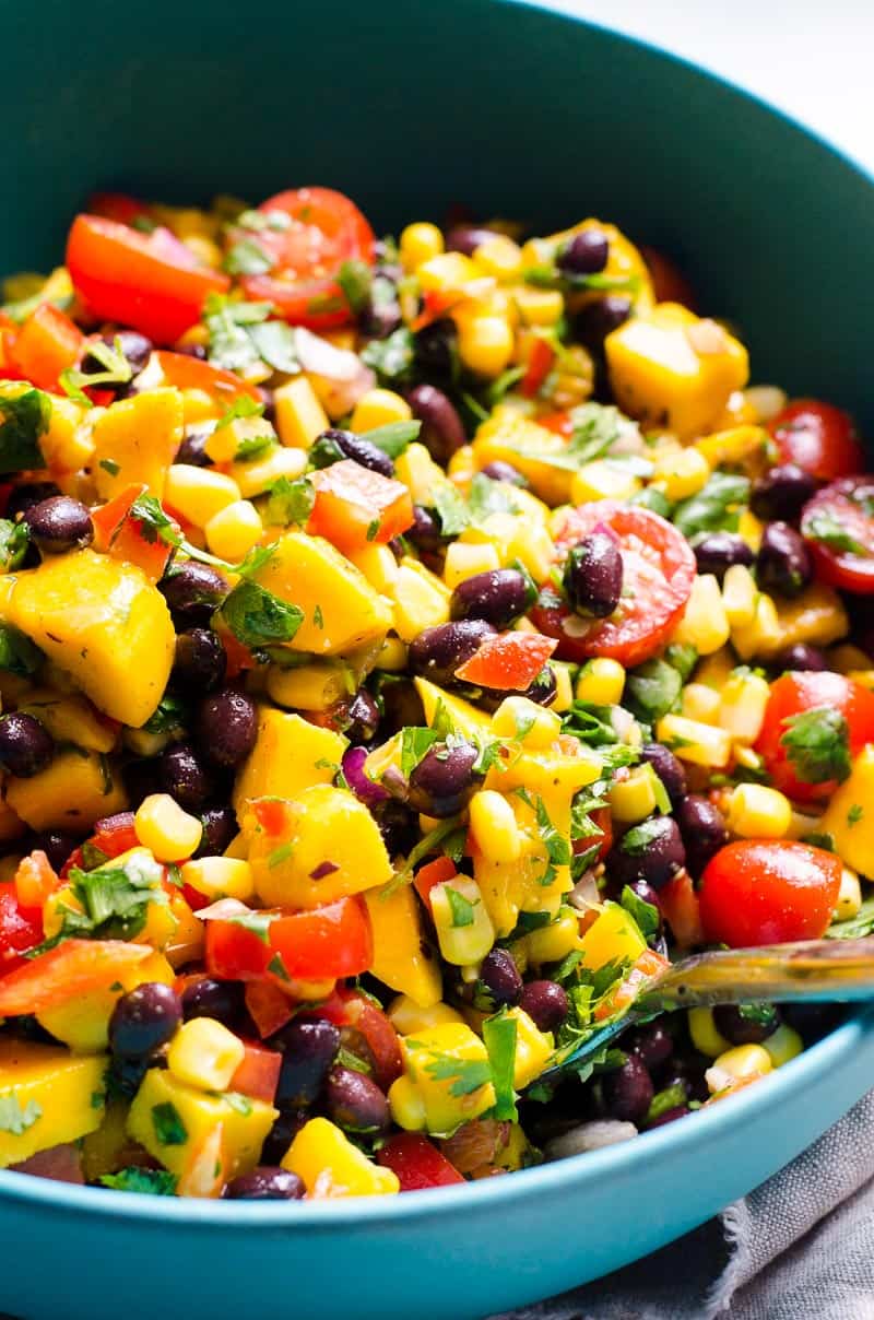 Mango black bean salad recipe with mango, tomatoes, bell pepper, cilantro and lime.