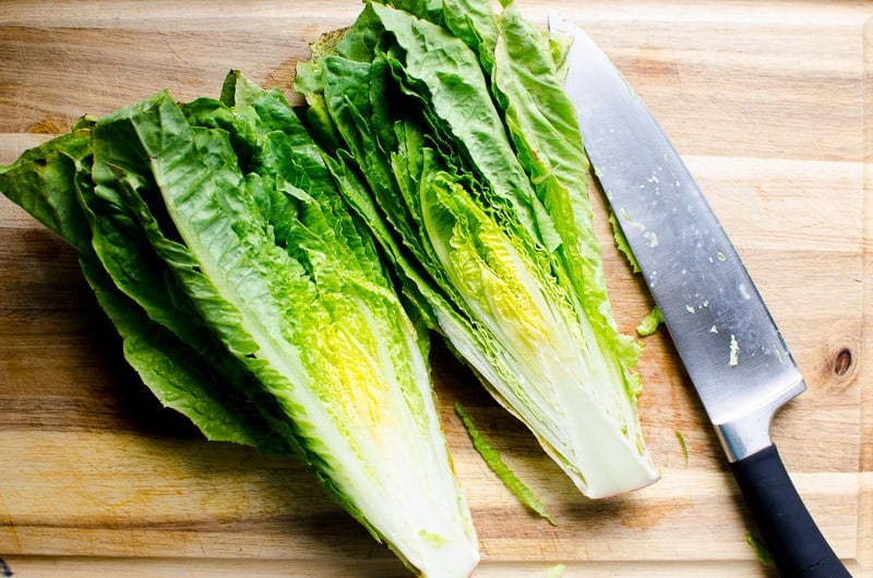 romaine on cutting wood block with knife