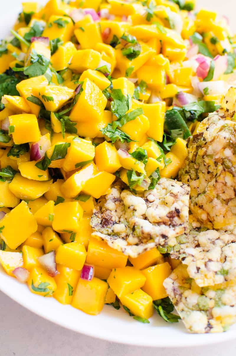 Fresh mango salsa with cilantro, red onion and served with chips.