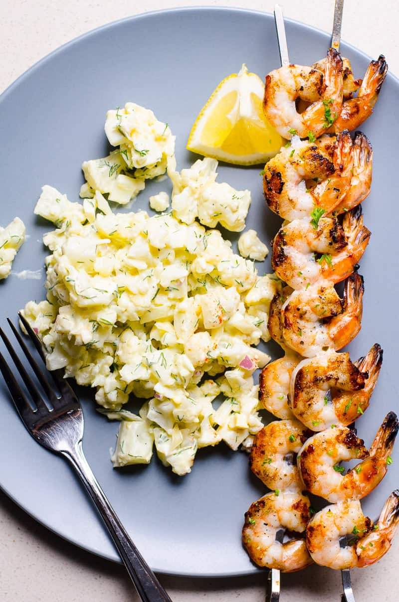 Grilled Shrimp Skewers served with cauliflower potato salad on a plate