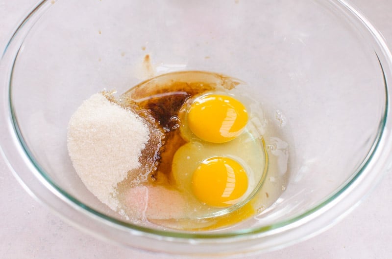 glass bowl with eggs and other almond flour cookies ingredients