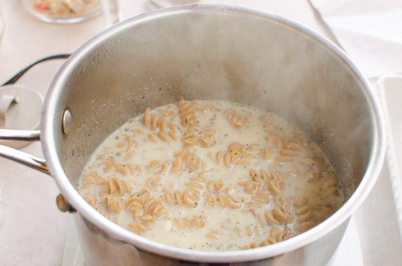 Pasta in large stockpot with milk liquids.
