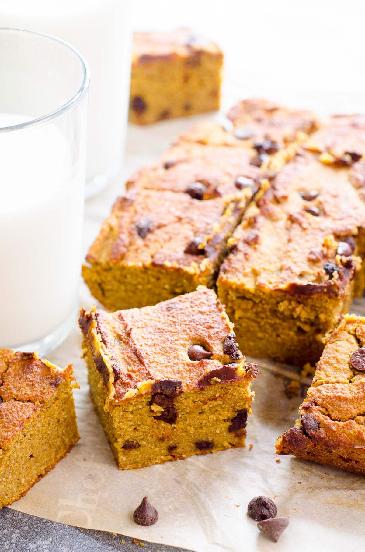 Healthy pumpkin bars cut into squares with glass of milk.