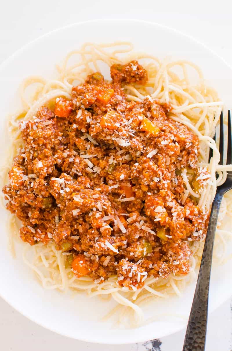 Instant Pot Bolognese recipe on white plate and black fork