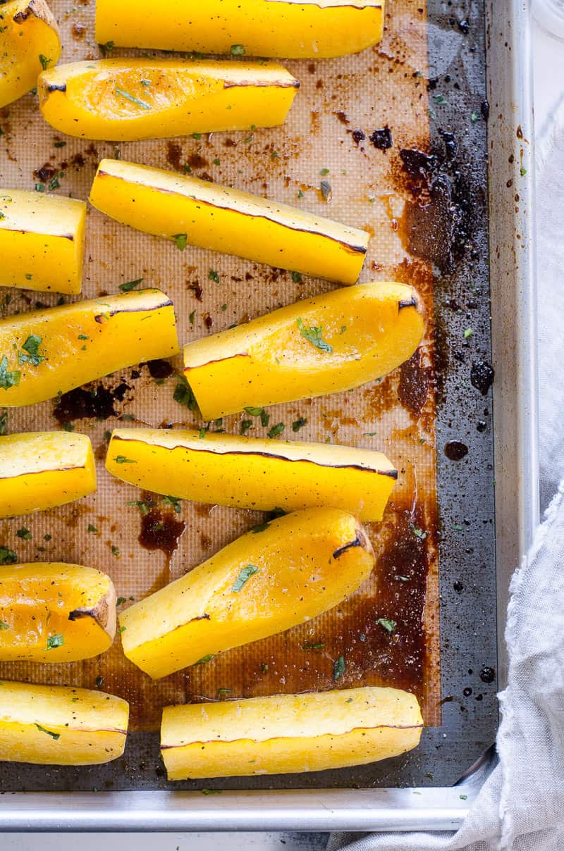 Baked Butternut Squash garnished with parsley on a tray
