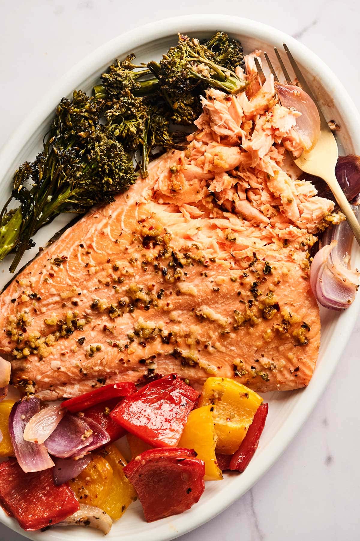 Flaked salmon with vegetables on a platter.