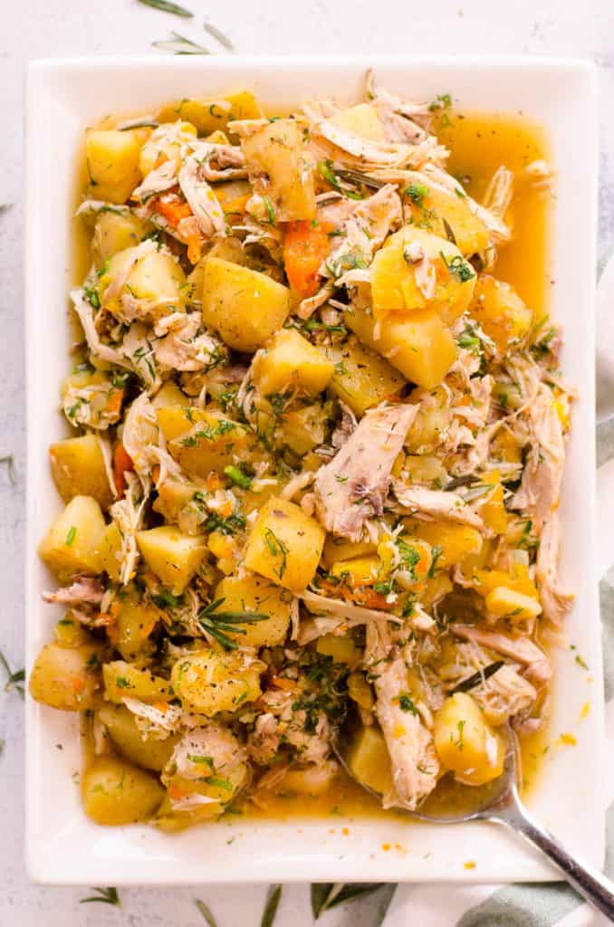 instant pot chicken and potatoes served on a white platter with a spoon