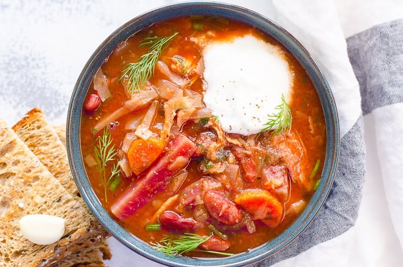 bowl of Instant Pot Borscht garnished with dill