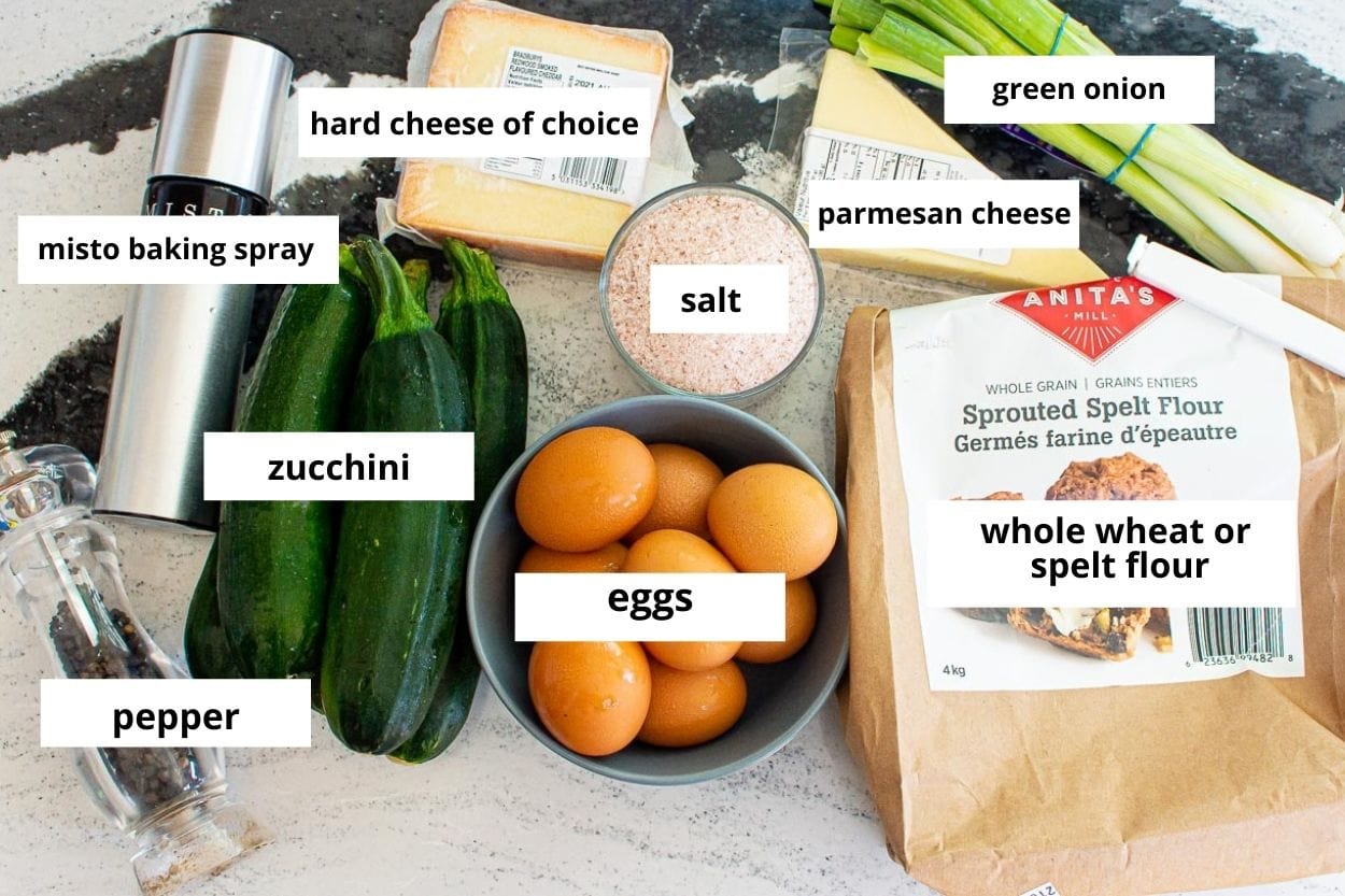 Zucchini, eggs, green onion, parmesan cheese, cheese block, salt, pepper, cooking spray, whole wheat spelt flour.