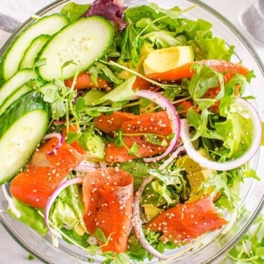 Easy smoked salmon salad in a bowl with cucumber, red onion and avocado.