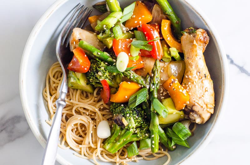 chicken stir fry served with noodles in a bowl