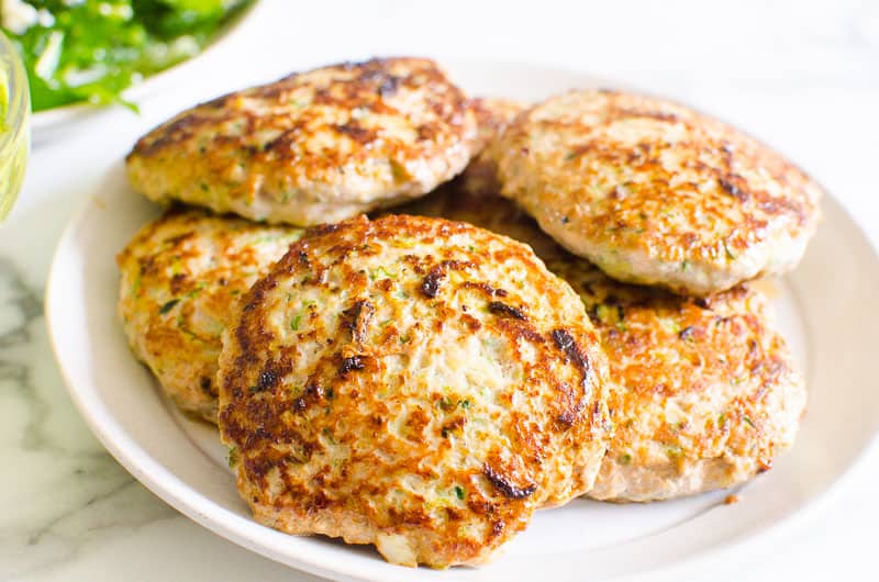 A pile of turkey burgers on a plate.