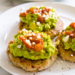 Healthy turkey burgers topped with guac and salsa.