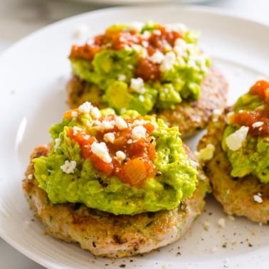 Healthy turkey burgers topped with guac and salsa.