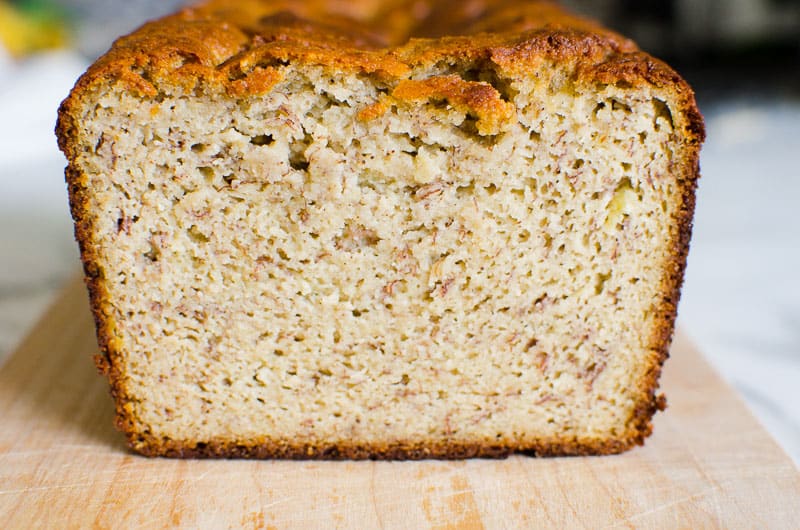 Sliced almond flour banana bread showing texture placed on a cutting board.