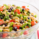 Healthy pasta salad with vegetables in a serving bowl.
