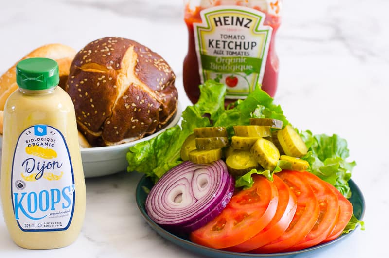 Buns, veggies, ketchup and mustard for healthy turkey burger toppings.
