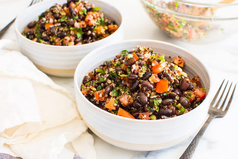 quinoa black bean salad in white bowls